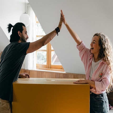 man and woman giving each other high five